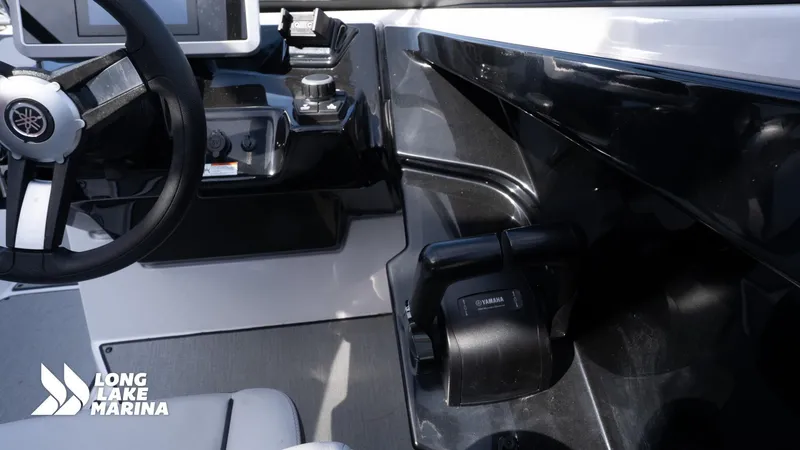 Slide: The Image of 2021 Yamaha AR250 boat dashboard with steering wheel and controls, Long Lake Marina branding. - 10