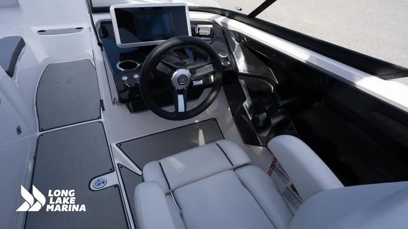 Slide: The Image of 2021 Yamaha Boats AR250 cockpit with steering wheel and dashboard, Long Lake Marina branding. - 9