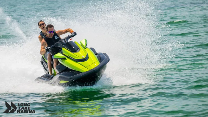 Slide: The Image of 2024 Yamaha FX Cruiser SVHO w/ Audio jet ski on water, two riders enjoying a splash. - 3