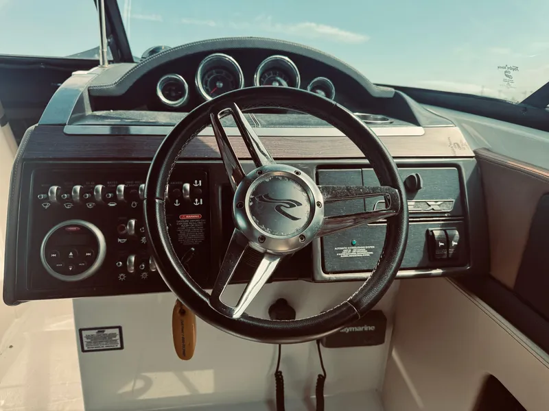 Slide: The Image of Steering wheel and dashboard of a 2015 Sea Ray 270 SLX boat. - 16