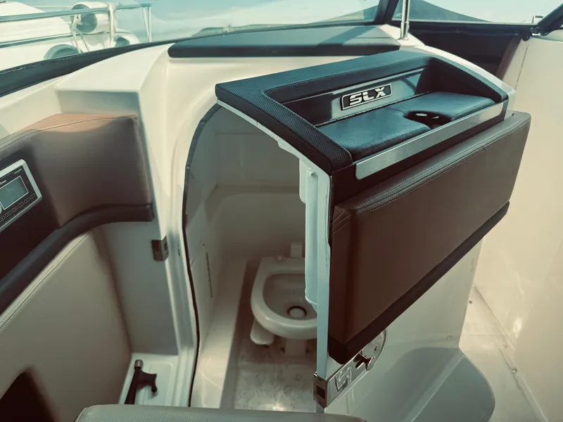 Slide: The Image of Interior view of a 2015 Sea Ray 270 SLX boat, featuring a compact marine toilet. - 17