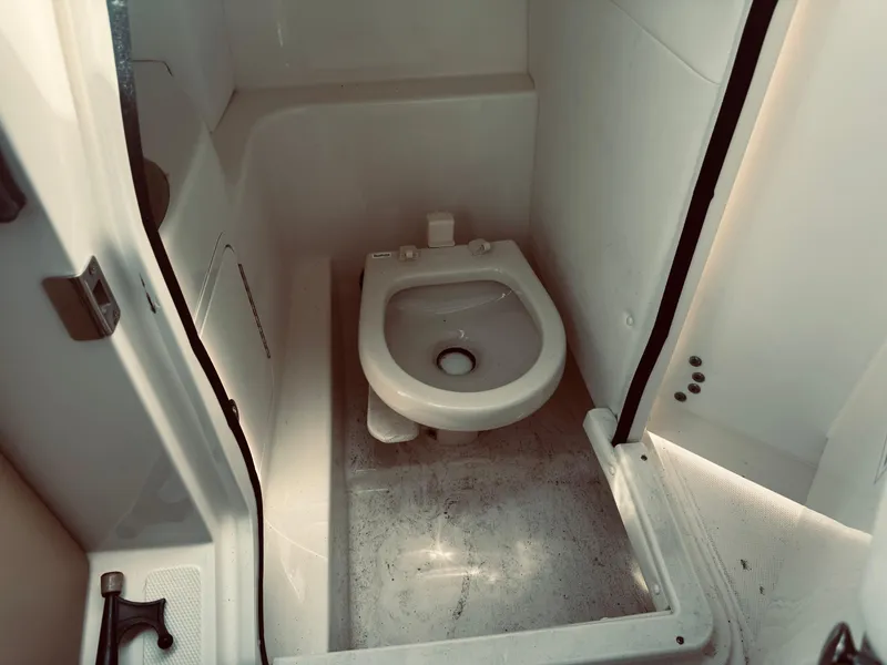 Slide: The Image of 2015 Sea Ray 270 SLX boat bathroom interior with compact toilet. - 18
