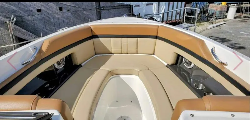 Slide: The Image of 2015 Sea Ray 270 SLX boat interior with tan seating and cup holders. - 3