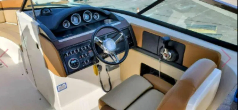Slide: The Image of 2015 Sea Ray 270 SLX boat dashboard with steering wheel and control panel. - 5