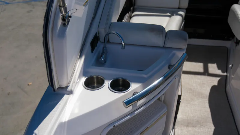 Slide: The Image of 2013 Regal 28 Express boat interior with sink and cup holders. - 13