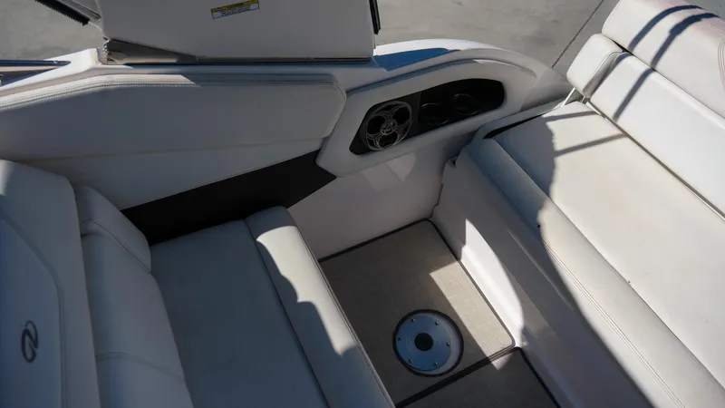 Slide: The Image of 2013 Regal 28 Express boat interior with white seating and cup holders. - 14