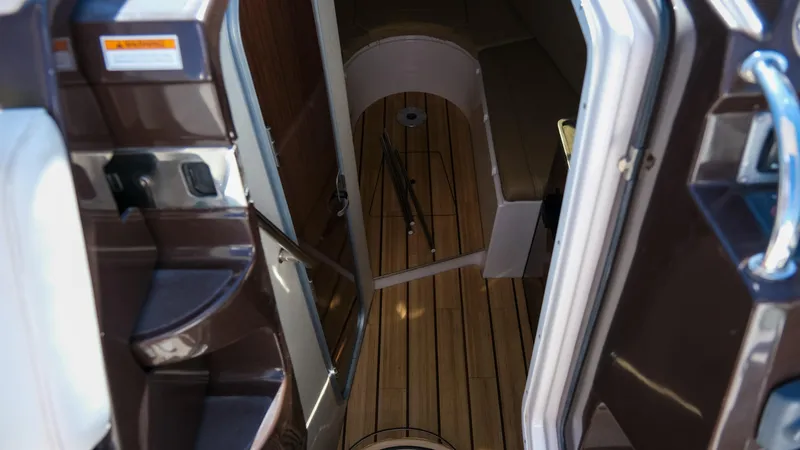Slide: The Image of Interior view of 2013 Regal 28 Express boat, featuring wooden flooring and seating area. - 17