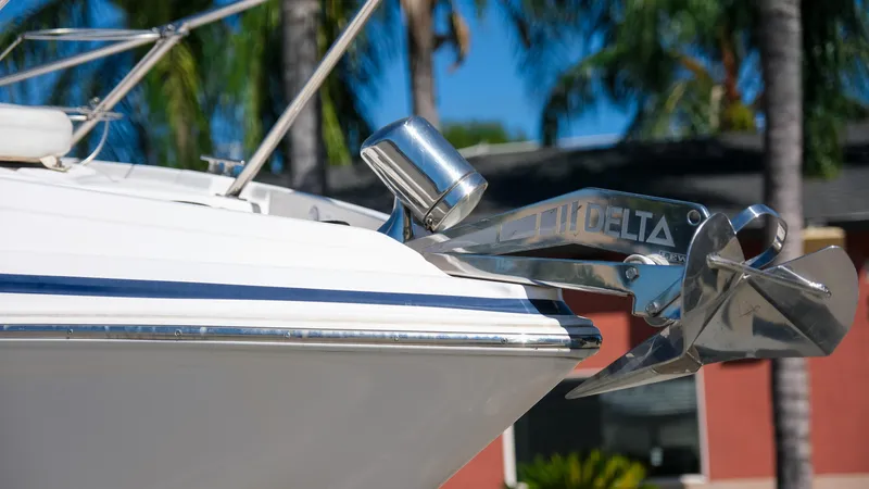 Slide: The Image of 2013 Regal 28 Express boat with Delta anchor, palm trees in background. - 2