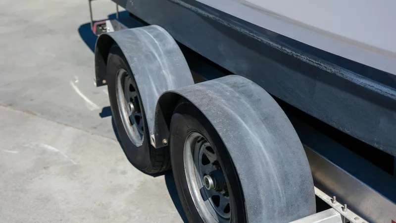 Slide: The Image of Trailer wheels of a 2013 Regal 28 Express boat on concrete surface. - 5