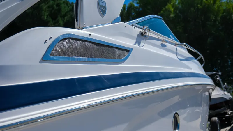 Slide: The Image of 2013 Regal 28 Express boat with sleek design and blue accents. - 6