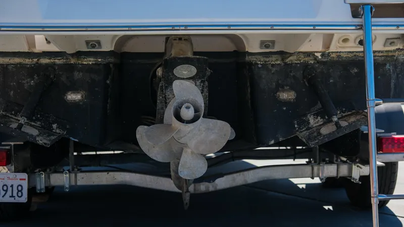 Slide: The Image of Rear view of a 2013 Regal 28 Express boat with visible propeller and trailer. - 8