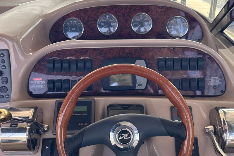 Slide: The Image of 2006 Sea Ray 360 Sundancer helm with wood steering wheel and instrument panel. - 15