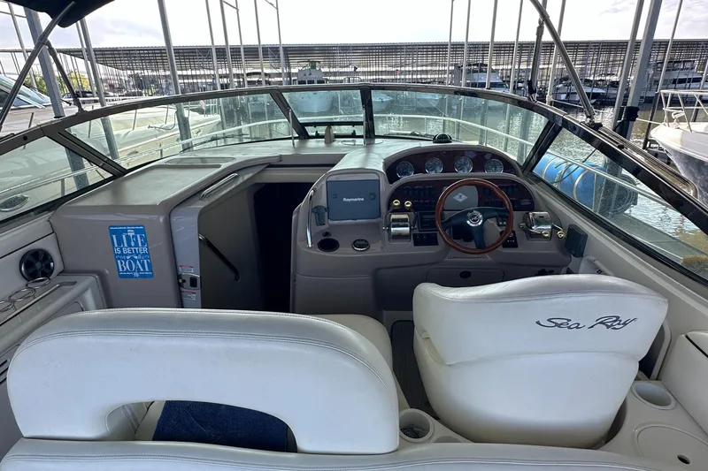 Slide: The Image of 2006 Sea Ray 360 Sundancer cockpit with steering wheel and control panel. - 19