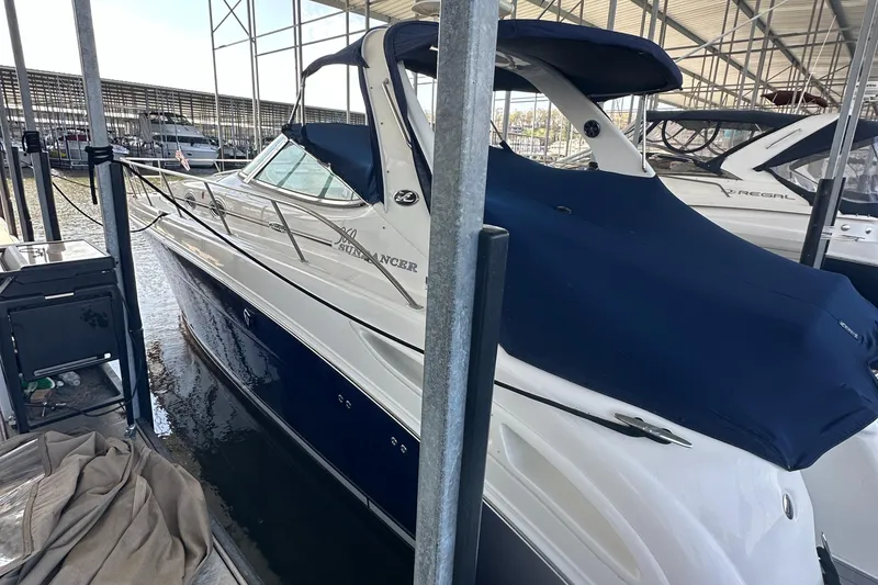 Slide: The Image of 2006 Sea Ray 360 Sundancer docked under a covered marina. - 2