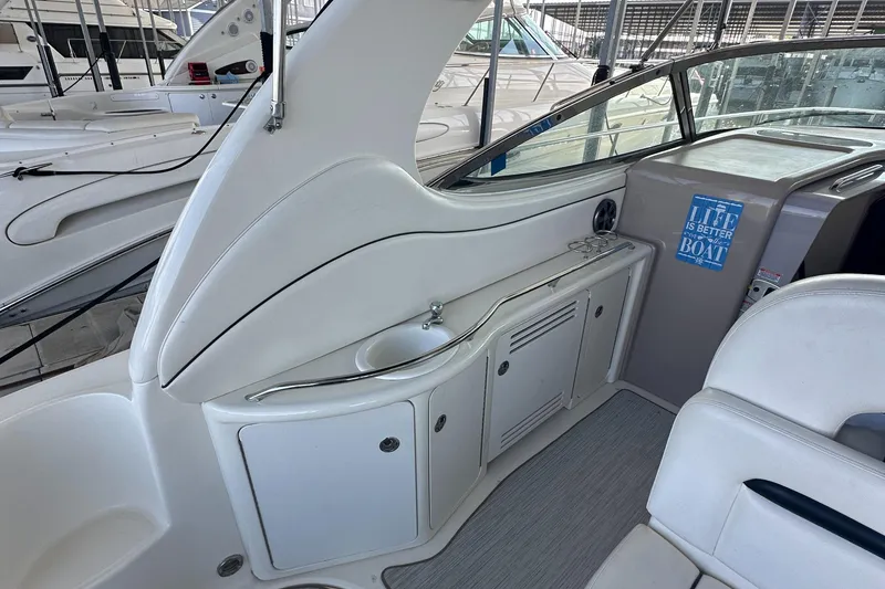 Slide: The Image of 2006 Sea Ray 360 Sundancer interior with sleek white cabinetry and compact sink. - 23