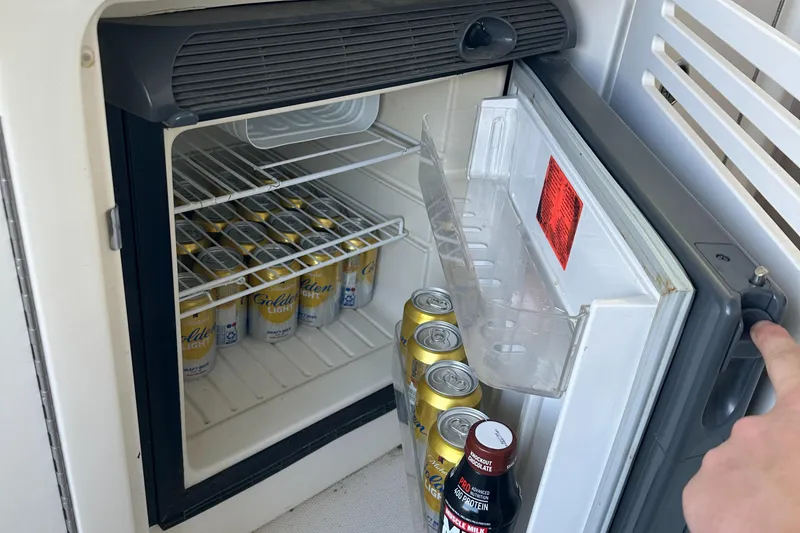 Slide: The Image of Mini fridge stocked with beverages on a 2006 Sea Ray 360 Sundancer boat. - 25