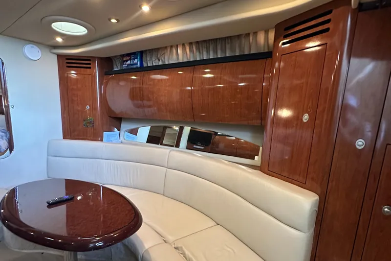 Slide: The Image of Luxurious interior of 2006 Sea Ray 360 Sundancer with wood cabinets and leather seating. - 28