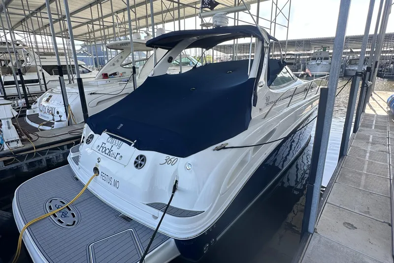Slide: The Image of 2006 Sea Ray 360 Sundancer docked in a marina, covered with a navy blue tarp. - 3