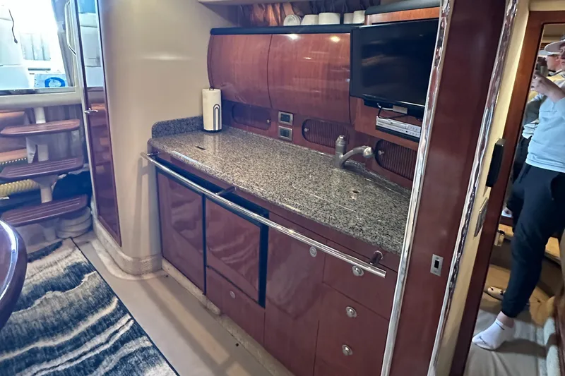 Slide: The Image of 2006 Sea Ray 360 Sundancer interior with modern kitchen, granite countertop, and wood cabinetry. - 31