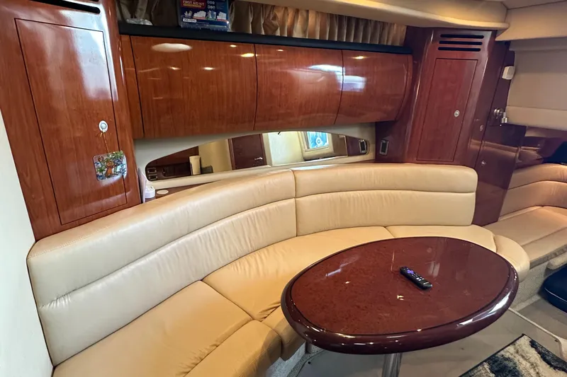 Slide: The Image of Luxurious interior of 2006 Sea Ray 360 Sundancer with leather seating and wooden cabinetry. - 32