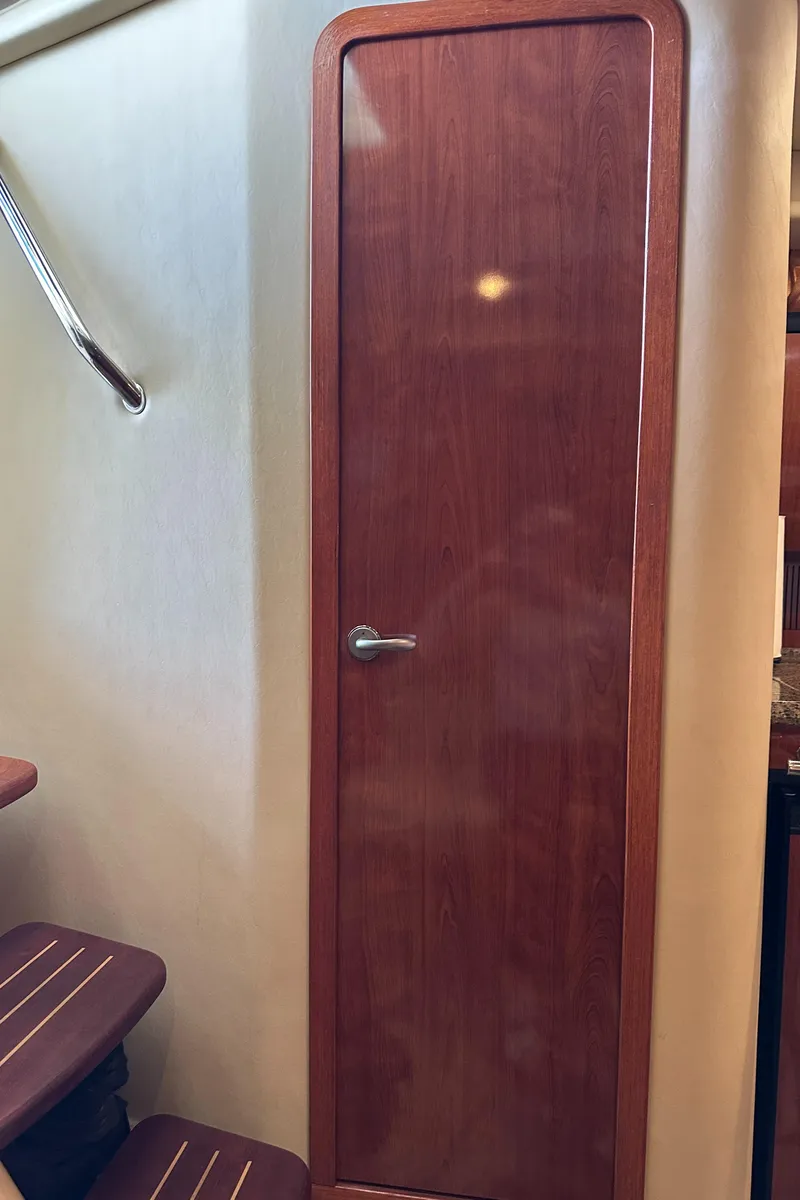 Slide: The Image of Wooden cabin door inside 2006 Sea Ray 360 Sundancer yacht, with adjacent stairs. - 34