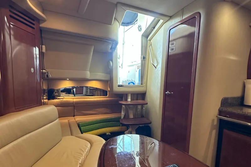 Slide: The Image of Interior of 2006 Sea Ray 360 Sundancer yacht with beige seating and wooden accents. - 35