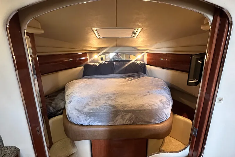 Slide: The Image of 2006 Sea Ray 360 Sundancer cabin with cozy bed and elegant wood paneling. - 39