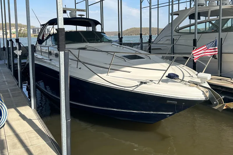 Slide: The Image of 2006 Sea Ray 360 Sundancer docked, featuring sleek design and American flag. - 4