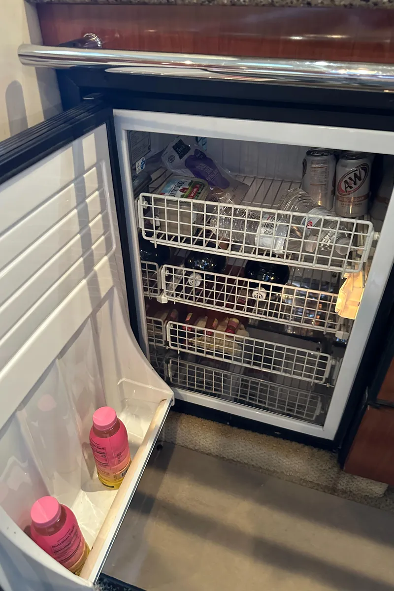 Slide: The Image of Mini fridge inside 2006 Sea Ray 360 Sundancer yacht, stocked with beverages and snacks. - 43