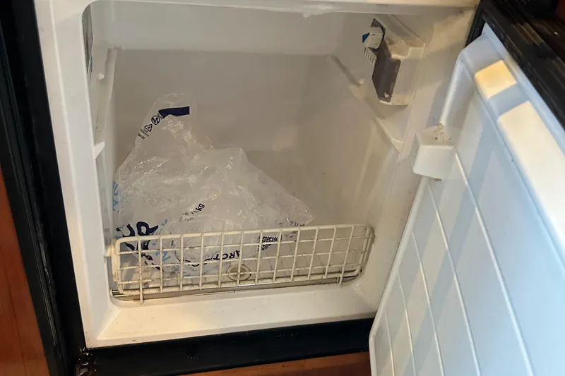 Slide: The Image of Empty freezer compartment on a 2006 Sea Ray 360 Sundancer boat. - 45