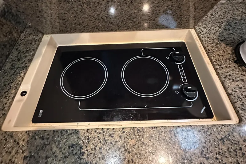 Slide: The Image of Stovetop on 2006 Sea Ray 360 Sundancer yacht, featuring two burners and granite countertop. - 46