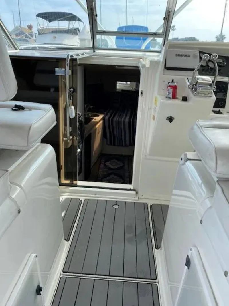 Slide: The Image of 1995 Wellcraft 330 Coastal boat interior with seating and cabin entrance. - 13