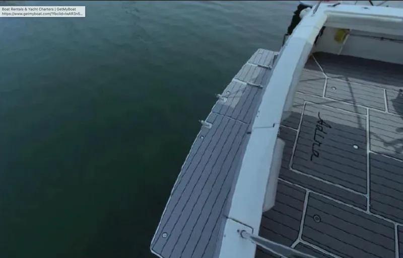 Slide: The Image of 1995 Wellcraft 330 Coastal boat deck with gray flooring, docked on calm water. - 17