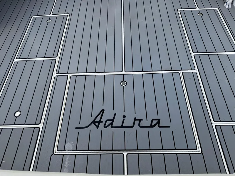 Slide: The Image of Gray deck of 1995 Wellcraft 330 Coastal boat with "Adira" text. - 19