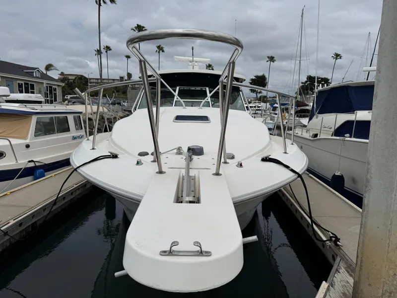 Slide: The Image of 1995 Wellcraft 330 Coastal boat docked at marina, surrounded by other vessels. - 2
