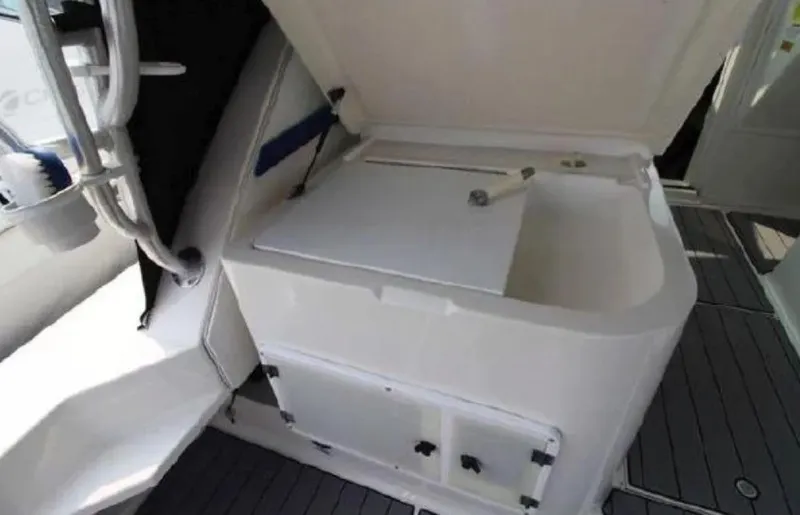 Slide: The Image of 1995 Wellcraft 330 Coastal boat interior with open storage compartment. - 23