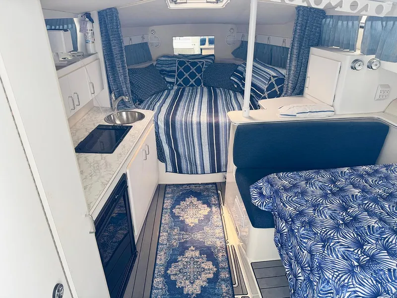Slide: The Image of Interior of 1995 Wellcraft 330 Coastal boat with blue and white decor. - 24