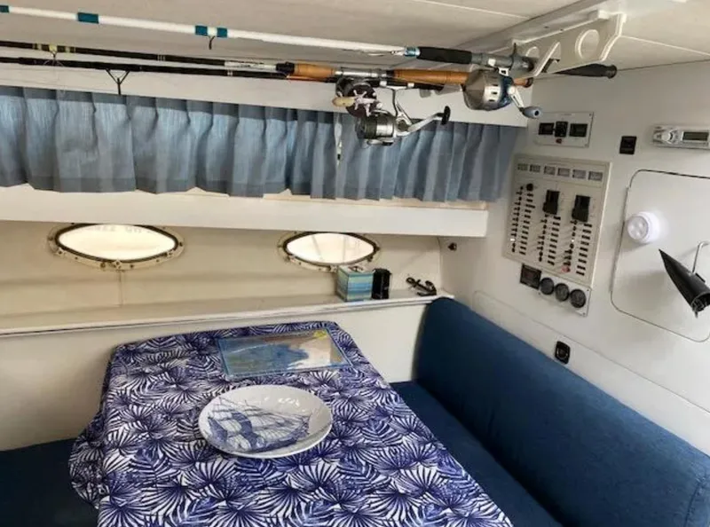 Slide: The Image of Interior of 1995 Wellcraft 330 Coastal boat with fishing rods and nautical-themed decor. - 29