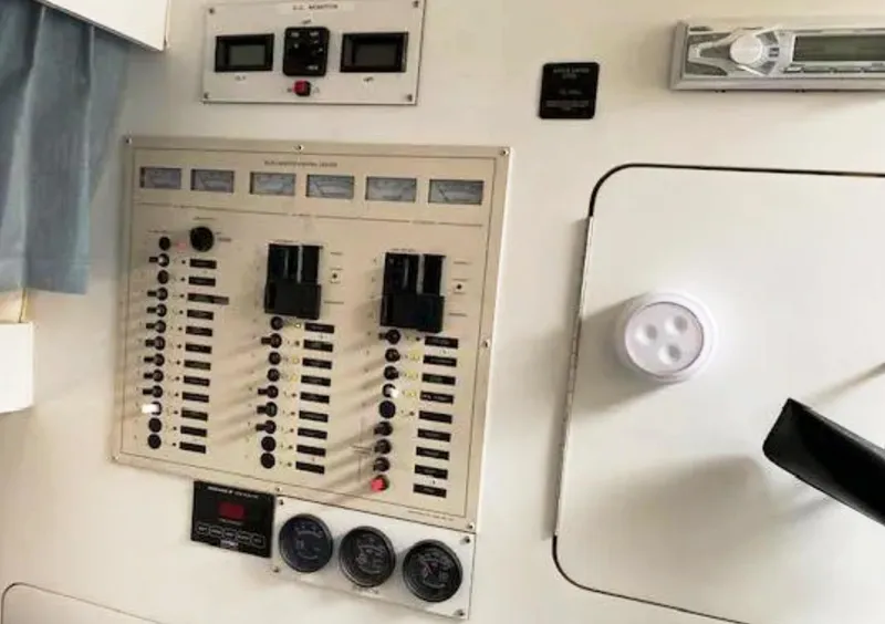 Slide: The Image of Control panel of a 1995 Wellcraft 330 Coastal boat, featuring switches and gauges. - 31
