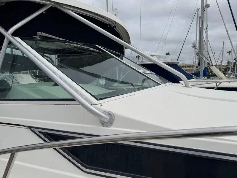 Slide: The Image of 1995 Wellcraft 330 Coastal boat with sleek design, docked in a marina. - 8