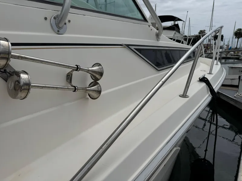 Slide: The Image of 1995 Wellcraft 330 Coastal boat with stainless steel railings and docked in a marina. - 9