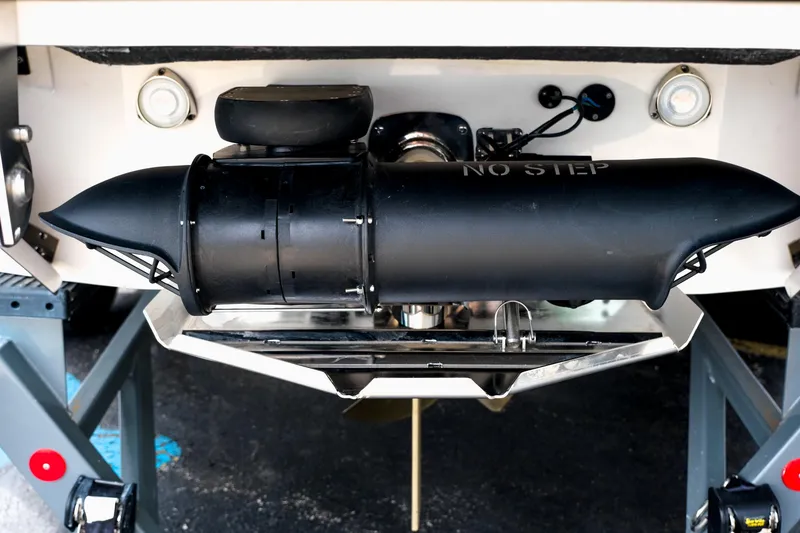 Slide: The Image of 2025 MasterCraft XStar 25 boat stern with "No Step" warning on black component. - 10