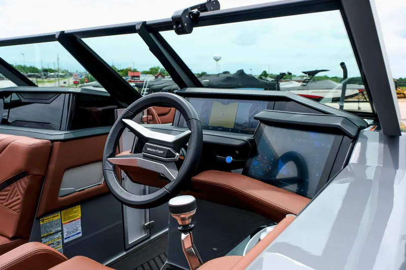 Slide: The Image of 2025 MasterCraft XStar 25 boat interior with modern dashboard and steering wheel. - 12