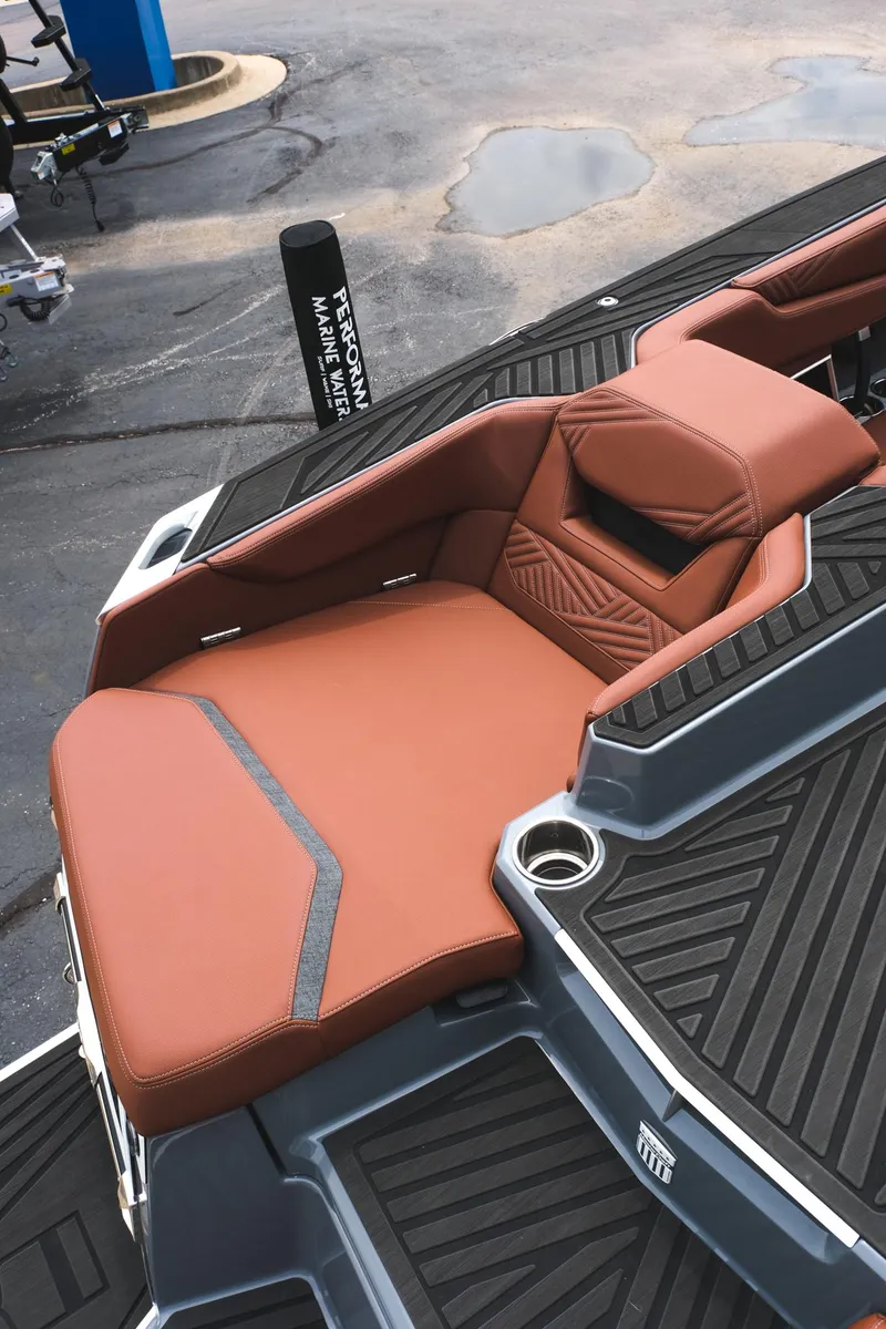 Slide: The Image of 2025 MasterCraft XStar 25 boat with luxurious brown seating and sleek design. - 17