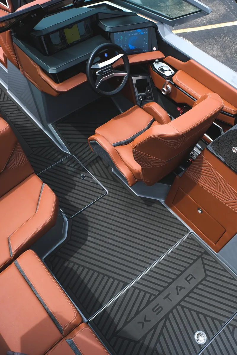 Slide: The Image of 2025 MasterCraft XStar 25 interior with luxurious seating and advanced dashboard features. - 22