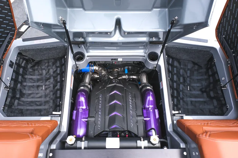 Slide: The Image of 2025 MasterCraft XStar 25 engine compartment with high-performance components and vibrant purple accents. - 25