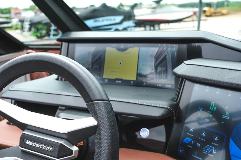 Slide: The Image of 2025 MasterCraft XStar 25 dashboard with advanced digital displays and steering wheel. - 26