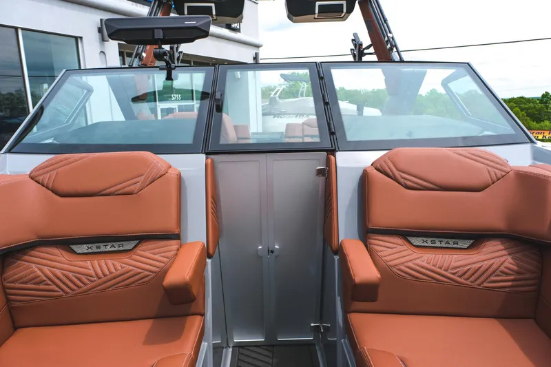 Slide: The Image of 2025 MasterCraft XStar 25 boat interior with brown leather seats and sleek design. - 28