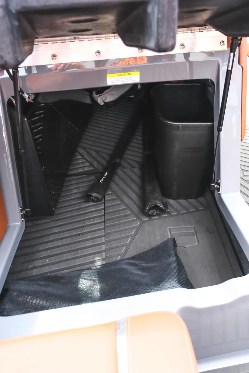 Slide: The Image of 2025 MasterCraft XStar 25 storage compartment with black interior and organized space. - 32