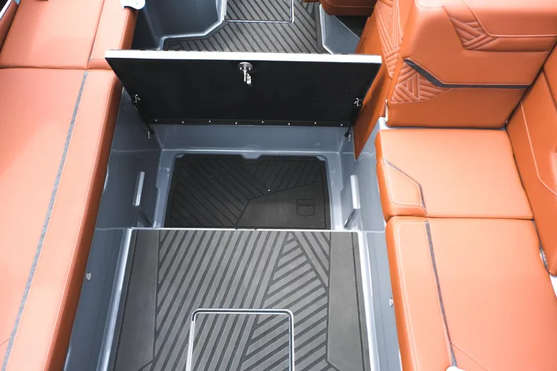 Slide: The Image of 2025 MasterCraft XStar 25 interior with orange seating and black flooring. - 33